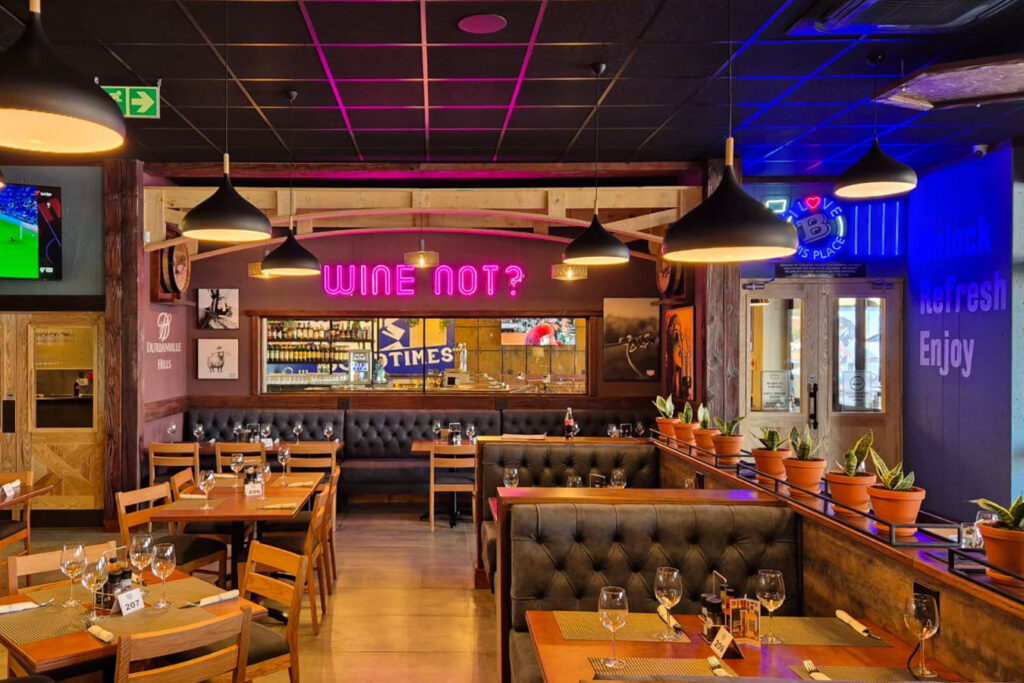 A cozy restaurant featuring tables, chairs, and a television for entertainment.